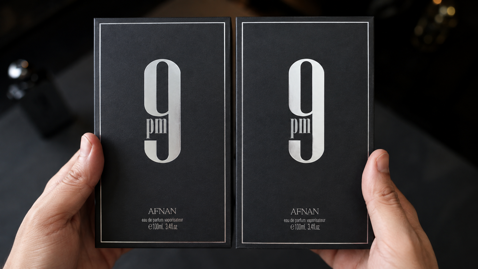 Two similar perfume boxes side by side under close inspection